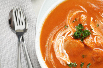 Delicious butter chicken served on table, top view. Traditional Murgh Makhani dish