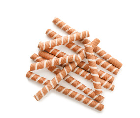 Tasty wafer roll sticks on white background, top view. Crispy food