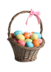 Fototapeta na wymiar Wicker basket with painted Easter eggs on white background