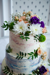 Sweet wedding cake decorated with fresh flowers