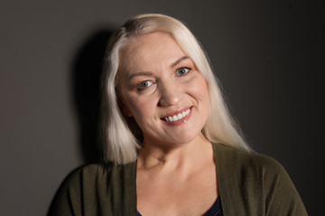 Portrait of mature woman on black background