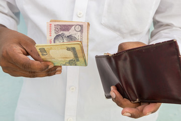 Closeup of Man hands taking Indian currency out of his wallet
