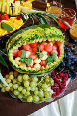 sliced fruits are beautifully arranged on a plate
