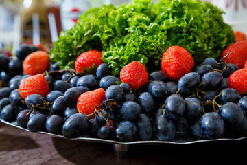sliced fruits are beautifully arranged on a plate