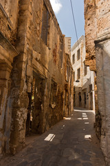 Narrow winding street at old venetian harbor of Chania, island of Crete, Greece