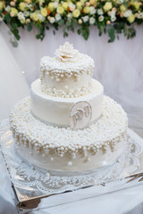 Sweet wedding cake decorated with fresh flowers