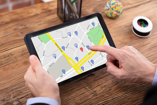 Person Using GPS Map On Tablet