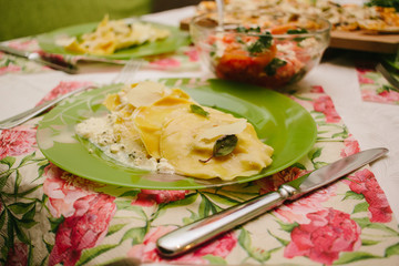 Ravioli and salad. Table served for party.