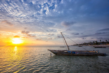 Fototapeta na wymiar Boat of a fisherman on a tropical beach, Zanzibar, Tanzania