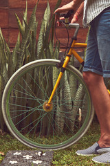 Naklejka premium Attractive man standing with old bicycle.