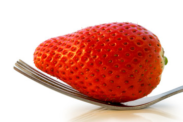 Strawberry with fork isolated on white background