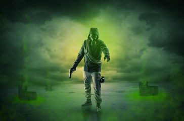 Fototapeta premium Masked unrecognizable guard in an abandoned space after explosion 