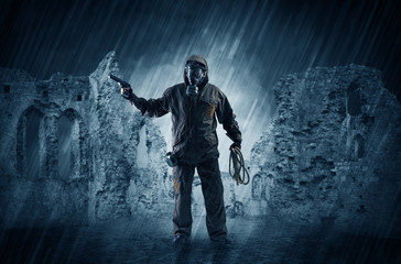 Fototapeta na wymiar Hazard, menace man in a ruined crumbly building with arms on his hand 