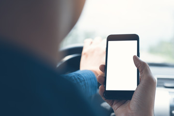 Man using smartphone inside a car