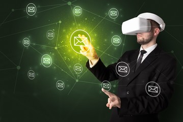 Young businessman in virtual reality glasses organize online network communication
