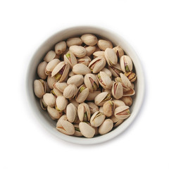 Pistachios in a bowl isolated on white background