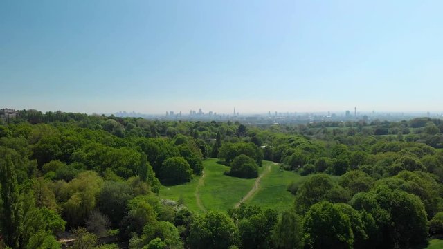 london skyline reveal over hampstead heath park aerial view sunny blue sky day summer
