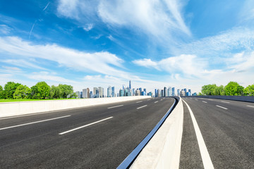 Fototapeta premium Empty asphalt road and panoramic city skyline with buildings in Shanghai