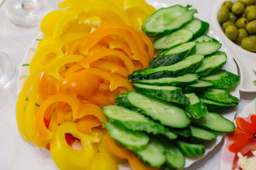 Fresh vegetable cutting on a white plate.
