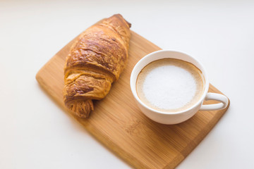 Traditional French breakfast of coffee and fresh croissant