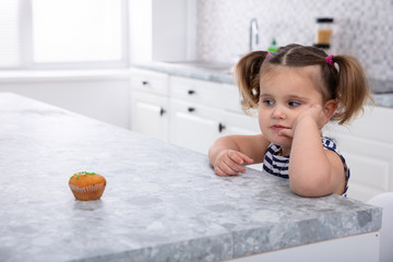 Pretty Girl Looking At Cupcake