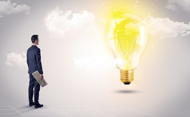 Fototapeta premium Businessman standing with his back with objects in his hand and looking at the globe, courtesy of NASA 