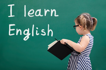 Cute Girl Writing Text Learn English On The Chalkboard