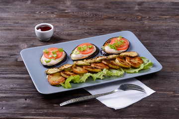 fried and fresh vegetables on a plate with cranberry sauce