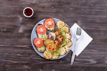 fried and fresh vegetables on a plate with cranberry sauce