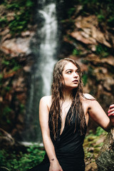 Young woman near a waterfall in the Black Forest