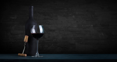 Expensive wine bottles collection and wooden barrel in the cellar, wine tasting and production...