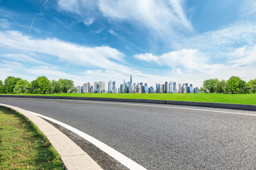 Empty asphalt road and panoramic city skyline with buildings in Shanghai