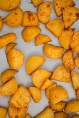Close up of baking tray with Patatas Bravas, a traditional Spanish tapas dish, potato cubes or wedges roasted, baked or deep fried until tender and cripsy on the outside
