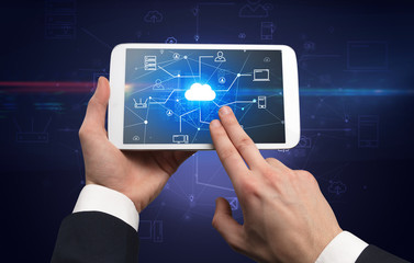 First person view of a hand using tablet with cloud office concept
