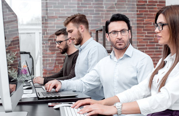 professional business team working on a PC in a modern office