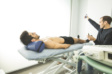Physiotherapist examining a patient with an ultrasound scan. Concept of advanced elbow physiotherapy