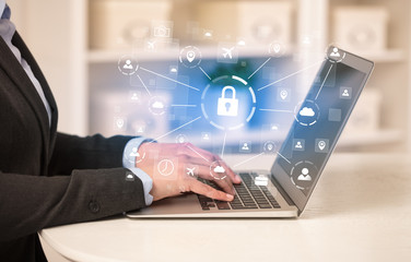 Business woman below chest working on laptop in a cozy homey environment with secured connection concept
