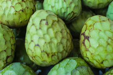 Delicious exotic cherimoya fruit in the market. Annona cherimola background.