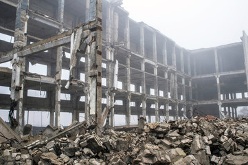 Frame of concrete piles of a large building in a thick foggy haze. The impact of the destruction. Background