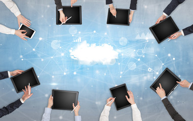 Group of people with devices in hands working on reports with online teamwork and cloud technology...
