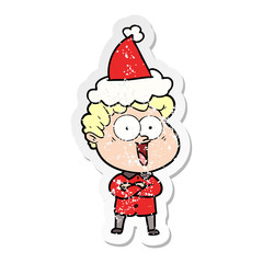 distressed sticker cartoon of a happy man wearing santa hat