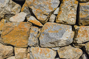 Stone masonry walls. Mountain colored natural stones. Natural stone