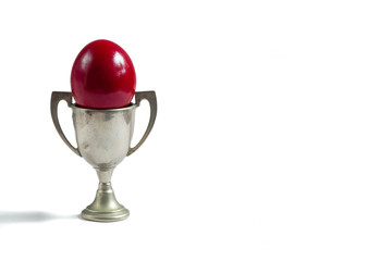 red egg in a silver cup isolated on white
