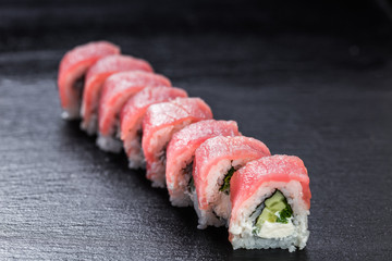 Tuna philadelphia roll with arranged on stone background