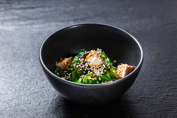 Seaweed salad with tofu and unagi sauce