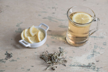 herbal tea and sage leaves on a wooden table