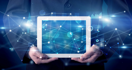 Elegant hand holding tablet with virtual database and network concept
