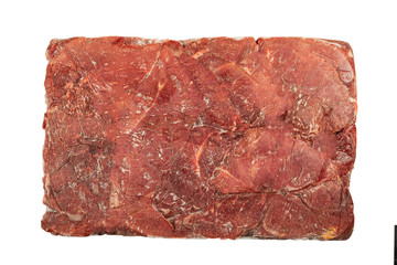 Frozen block of beef on a white background.