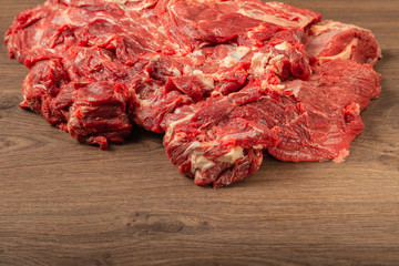 Raw fresh beef on a wooden background, catalog.