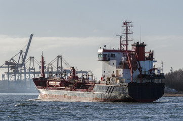 Obraz premium CHEMICAL/OIL PRODUCTS TANKER - Merchant ship is sailing along waterway to the port of Swinoujscie